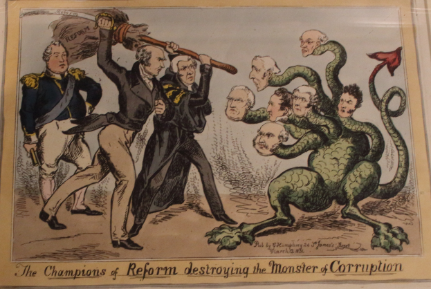 Eine Karikatur auf einem Blatt Papier, die Reformchampions bei der Besiegung eines Monsters namens "Korruption" zeigt, mit dem Text "Die Reformchampions zerstören das Monster der Korruption."
