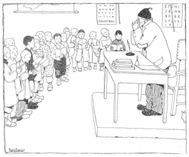 Ein Mann sitzt an einem Schreibtisch mit Büchern und Gegenständen vor einer Gruppe von Kindern, mit Papieren an der Wand dahinter, was auf eine Unterrichtssituation hinweist, in der er wahrscheinlich ein Lehrer ist.